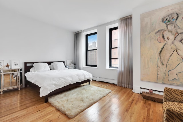 250 Mercer St Unit B603, New York City, NY 10012 - bedroom with a baseboard heating unit and light wood-style floors