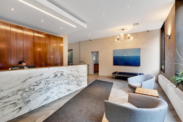 welcome area with an inviting chandelier and visible vents