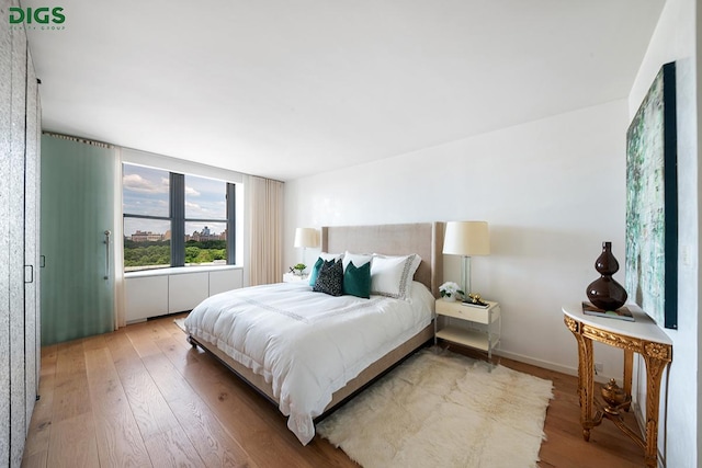 bedroom featuring baseboards and hardwood / wood-style floors