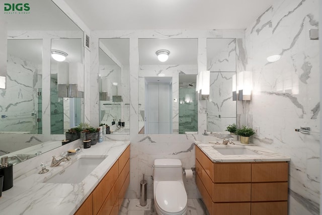 full bathroom featuring stone wall, a sink, tile walls, toilet, and marble finish floor