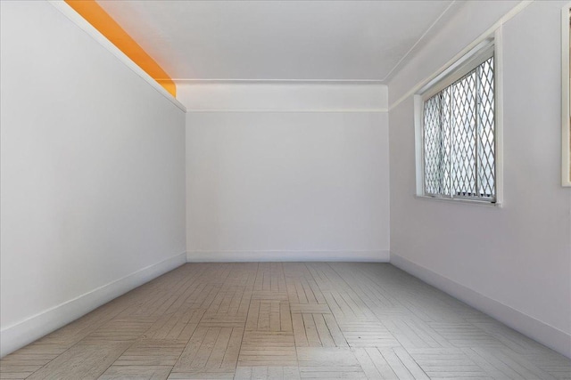 unfurnished room with baseboards