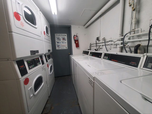 laundry area with stacked washer and clothes dryer and washing machine and clothes dryer