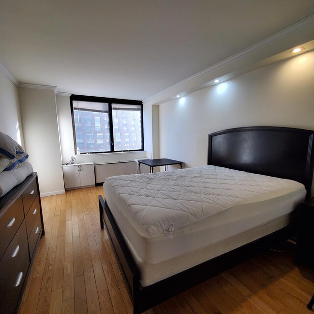 bedroom with recessed lighting, light wood-type flooring, and ornamental molding