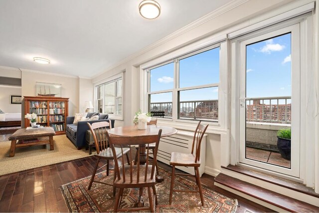 dining space featuring dark hardwood / wood-style flooring and crown molding