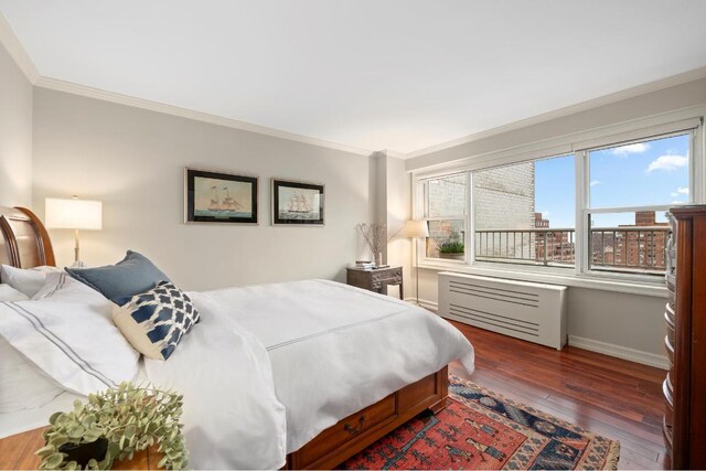 bedroom with dark wood-type flooring and ornamental molding