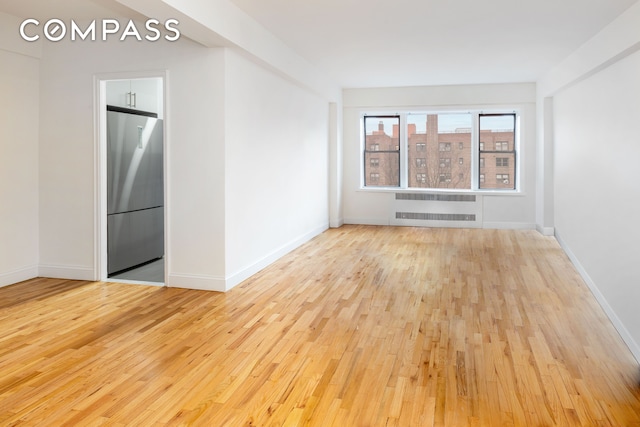 99-21 67th Rd Unit 7A, New York City, NY 11375 - empty room featuring hardwood / wood-style floors, baseboards, and radiator heating unit