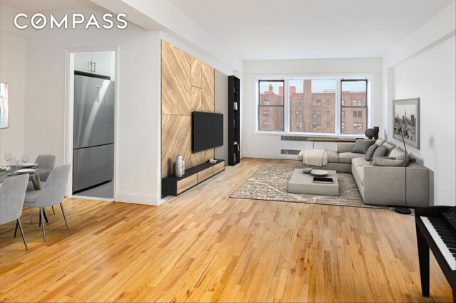 99-21 67th Rd Unit 7A, New York City, NY 11375 - living area featuring light wood-style flooring and baseboards