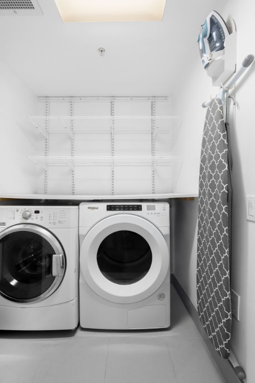 washroom featuring separate washer and dryer and light tile patterned flooring