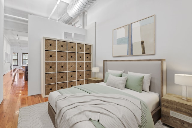 bedroom with wood-type flooring