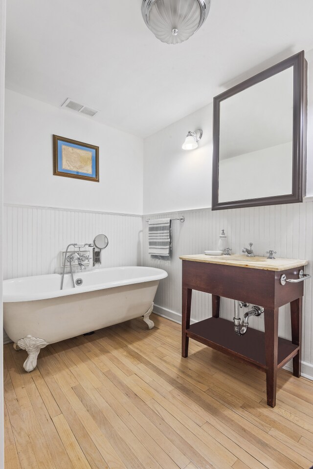 bathroom with hardwood / wood-style flooring and a bathing tub