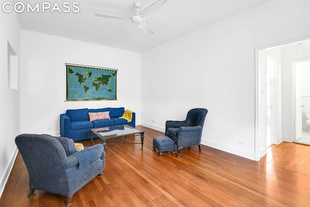 living area featuring ceiling fan and hardwood / wood-style flooring