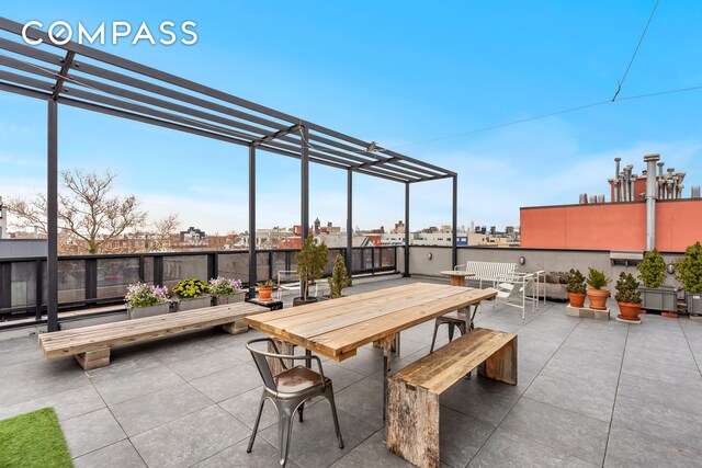 view of patio with outdoor dining space and a view of city