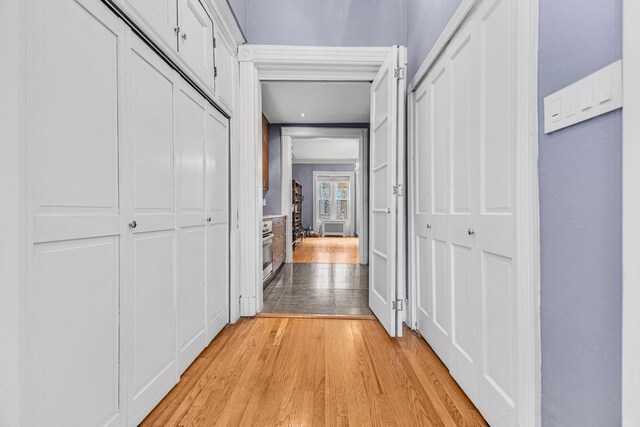 bedroom with a chandelier, crown molding, a fireplace, and hardwood / wood-style floors