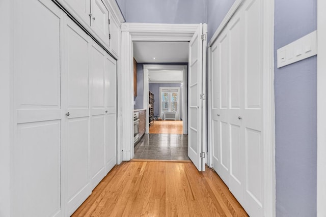 hallway with light hardwood / wood-style flooring