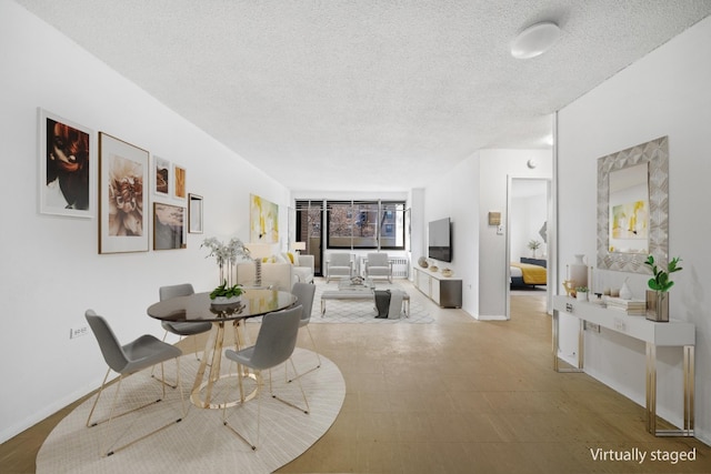 dining room featuring a textured ceiling