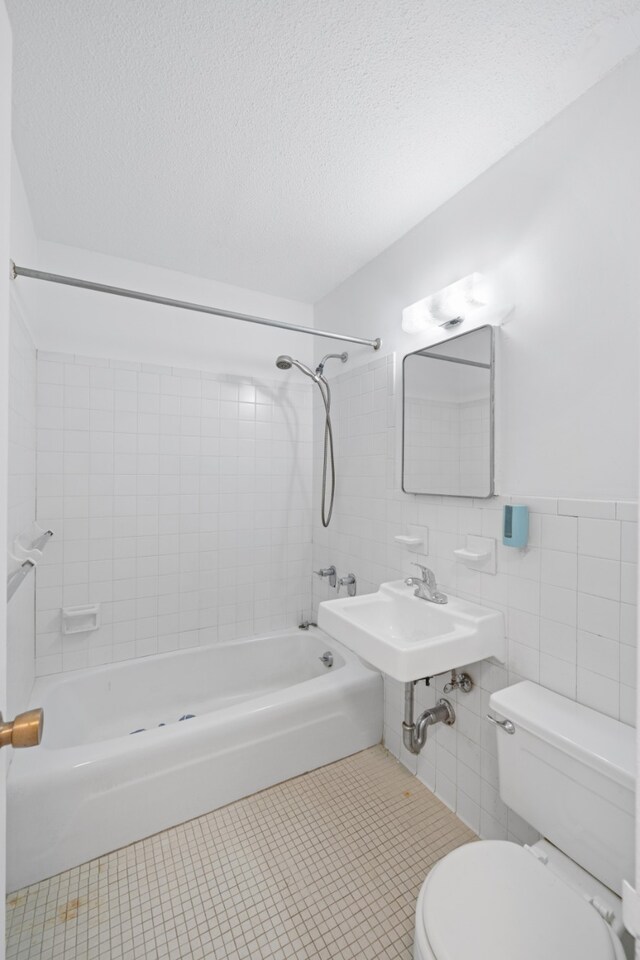 spare room featuring a textured ceiling and radiator