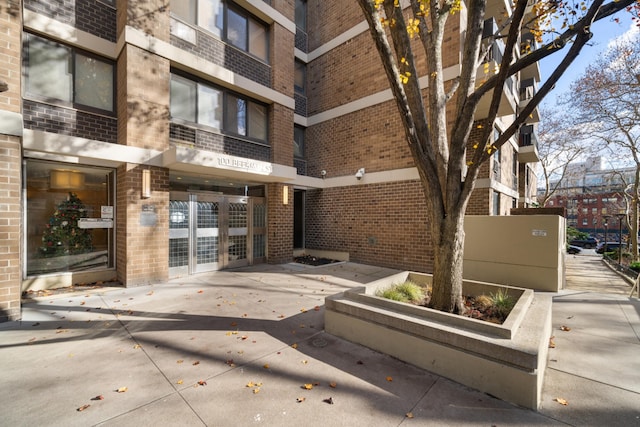 view of exterior entry with brick siding