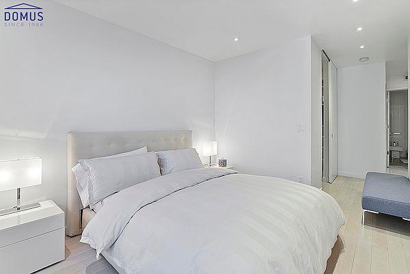bedroom with light wood finished floors and recessed lighting