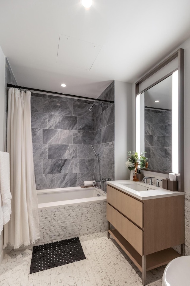 full bath featuring tiled shower / bath combo and vanity