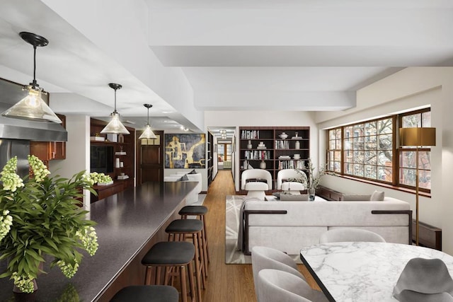 interior space featuring light wood finished floors and beam ceiling