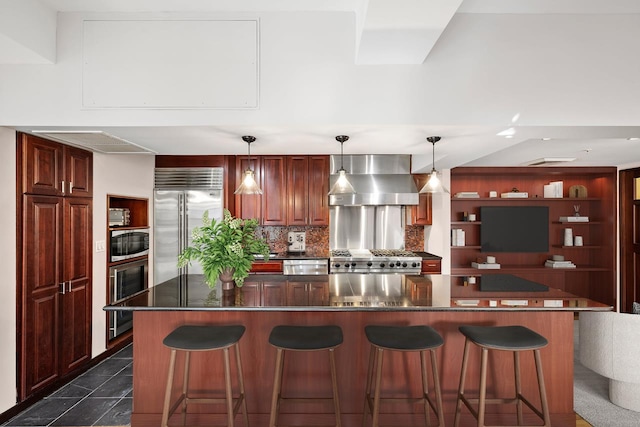 kitchen with wine cooler, a kitchen bar, built in appliances, decorative backsplash, and wall chimney range hood