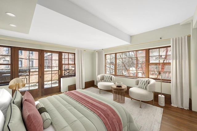 bedroom with multiple windows, recessed lighting, wood finished floors, and access to exterior