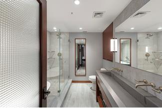 bathroom featuring toilet, a shower stall, visible vents, and wood finished floors