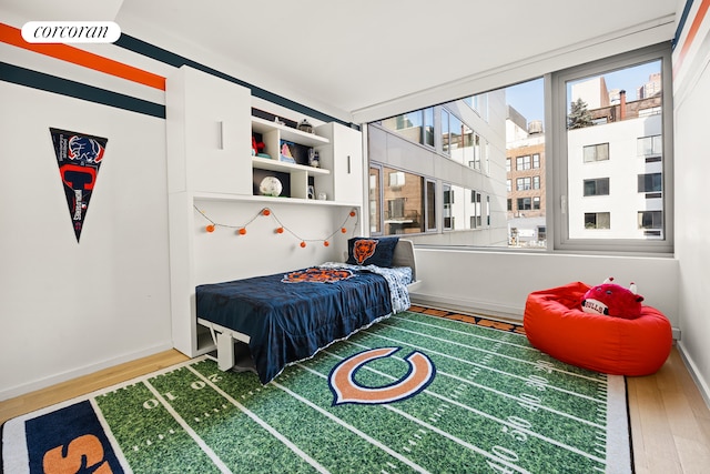 bedroom featuring wood finished floors and visible vents