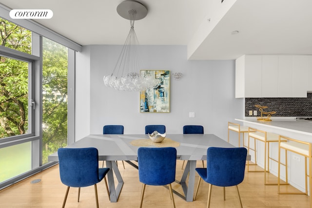 425 W 53rd St Unit 409, New York City, NY 10019 - dining room with a wall of windows and light wood-style floors