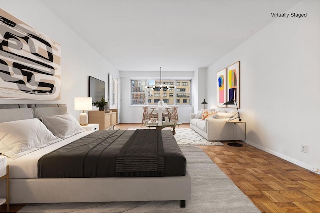 bedroom with an inviting chandelier and light parquet floors