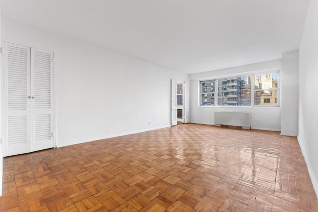 interior space with radiator and parquet floors