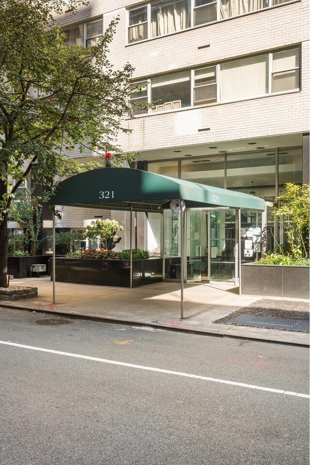 exterior space featuring covered parking and brick siding