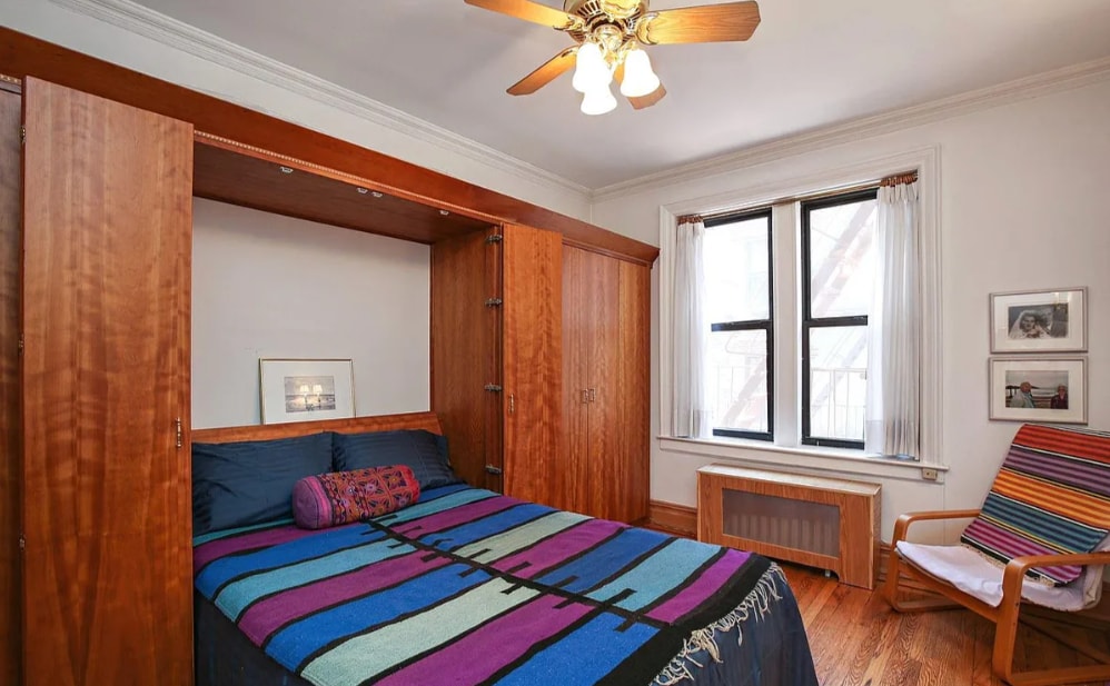 bedroom with radiator, ceiling fan, crown molding, and light hardwood / wood-style floors