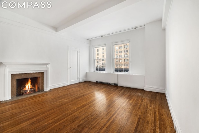 unfurnished living room featuring dark hardwood / wood-style floors