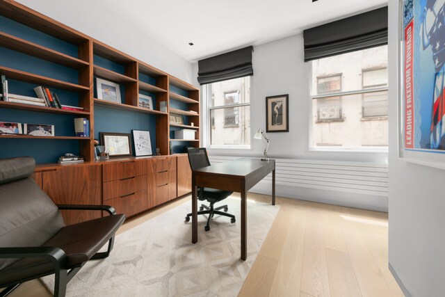 living room with light wood-type flooring and a fireplace