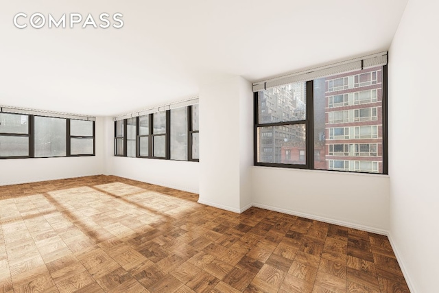 spare room featuring parquet flooring