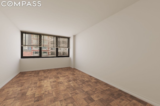 unfurnished room featuring parquet flooring