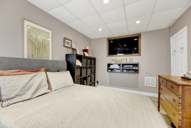 bedroom with a paneled ceiling, visible vents, baseboards, and recessed lighting