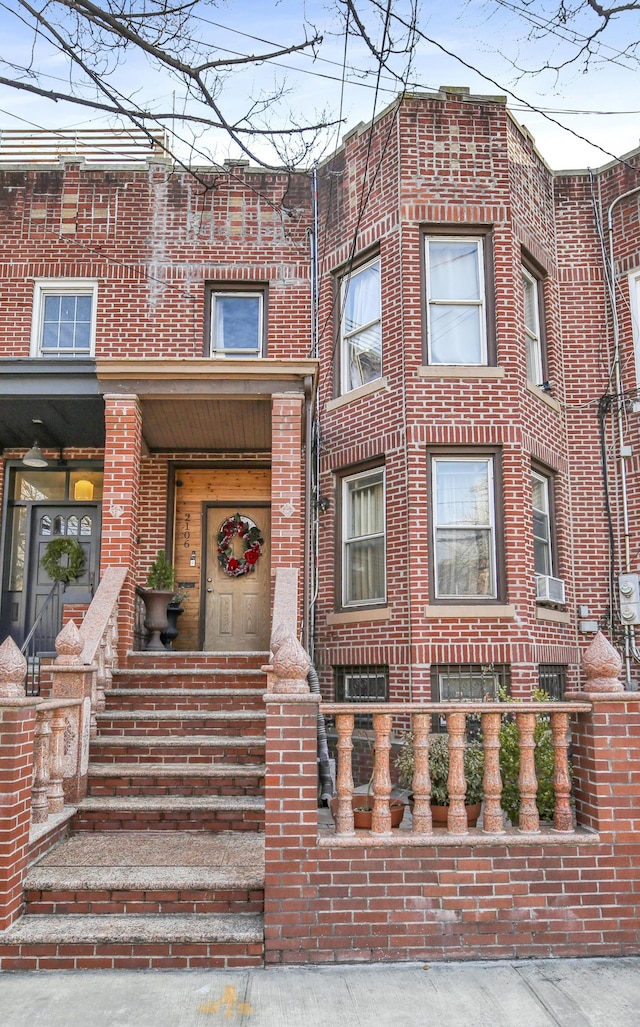 view of front facade featuring brick siding and cooling unit