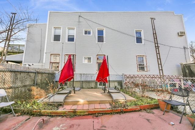 rear view of house with a patio and a fenced backyard