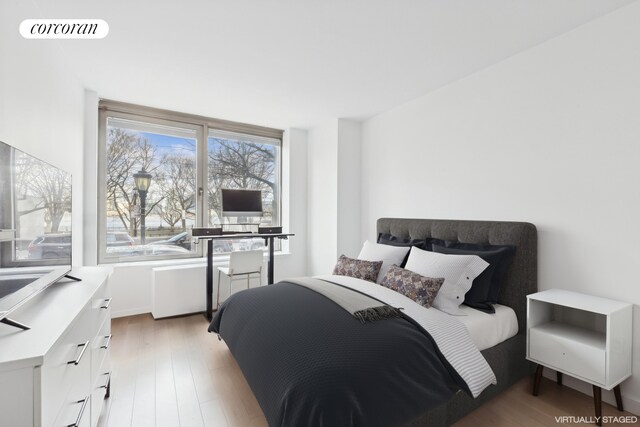 bedroom with light hardwood / wood-style floors