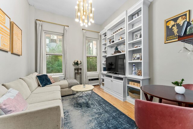 living room with wood-type flooring and a notable chandelier