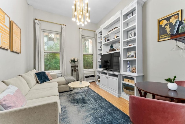 living room with an inviting chandelier and wood finished floors