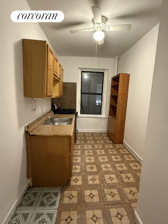 kitchen with tasteful backsplash, sink, and ceiling fan