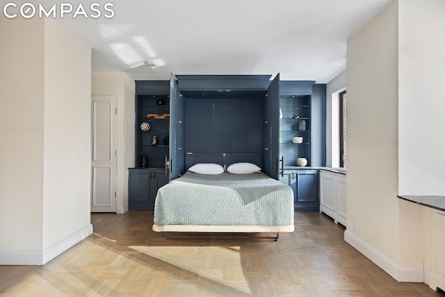 bedroom with light parquet floors