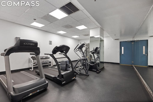 exercise room with a paneled ceiling