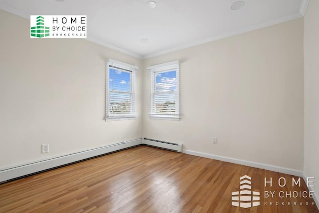 spare room featuring wood-type flooring, crown molding, and a baseboard heating unit