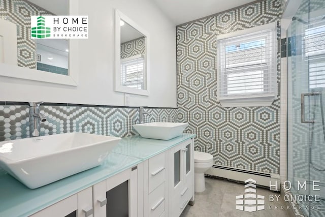 bathroom with toilet, a shower with door, vanity, and a baseboard radiator