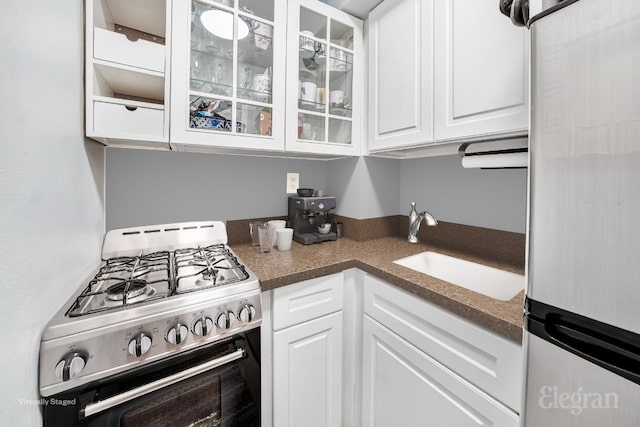 kitchen featuring white cabinetry, stainless steel appliances, and sink