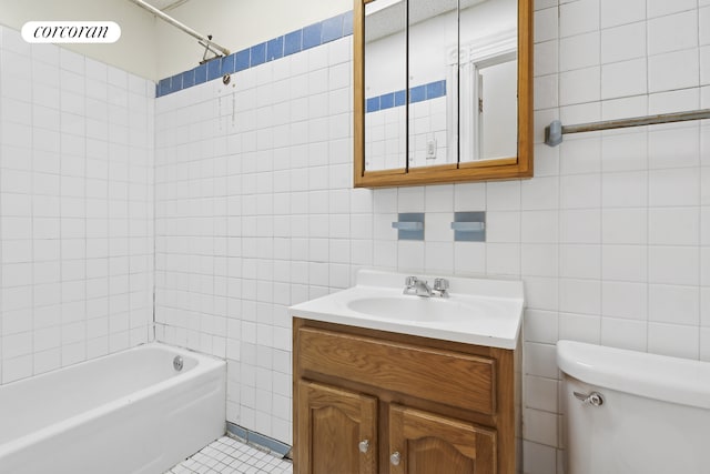 full bathroom featuring toilet, bathtub / shower combination, tile walls, and vanity